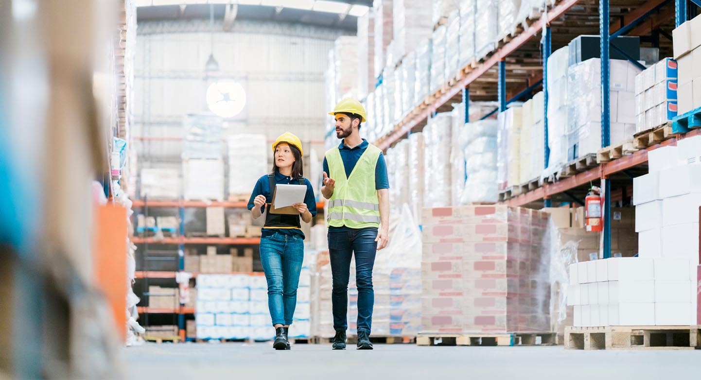 Two workers walking through a warehouse